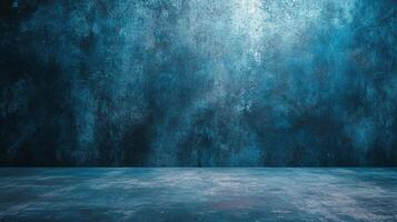 An atmospheric scene featuring a textured dark blue wall above a matching floor with soft lighting casting shadows and highlights. photo
