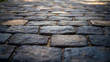 Stone pavers in close-up. The gray and brown stones form a textured surface, creating a sense of age, durability, and timelessness. photo