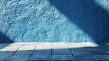 Abstract textured blue wall with geometric shadows. Tile floor reflects the light, creating a stark contrast with the shadowed wall. photo