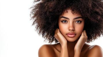Portrait of a beautiful woman with afro hair and elegant makeup, posing against a white background with a serene expression. photo