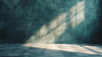 Sunlight streams across a mottled blue wall in an empty room, creating a dramatic light and shadow pattern. photo
