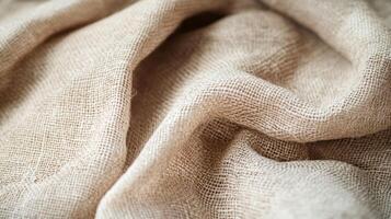 Beige fabric with a simple and slightly rough weave. It is folded with multiple layers and has a light-beige tone that is neutral. photo