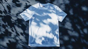 A simple white shirt is artistically displayed on a textured surface, bathed in dappled light and shadows of tree branches creating a serene scene. photo