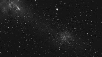 A monochrome view of a night sky with a multitude of stars. Space is vast and awe-inspiring, evoking tranquility. The cosmos awaits. photo