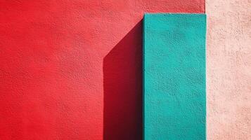 Colorful wall segments with red, turquoise, and pink hues. The shadow on the left makes for a sharp contrast with the bold colors. photo