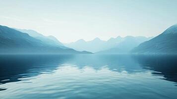 Serene landscape featuring a still lake reflecting hazy mountains under a pale sky, creating a peaceful and calming atmosphere. photo