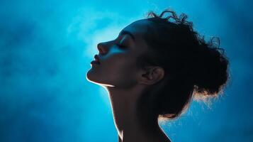 Pensive woman illuminated by ethereal lighting, evoking serenity and introspection. Portrait style, minimalist concept, artistic. photo