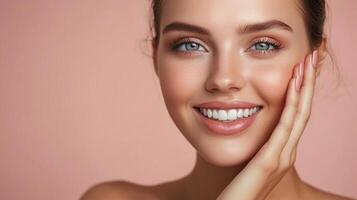 Radiant woman smiling, showing glowing skin and perfect teeth, in a beauty portrait with soft lighting against a simple background. photo