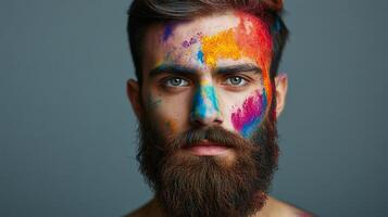 Man with vibrant face paint, a visual artist showcasing creativity and self-expression, set against a simple background. photo