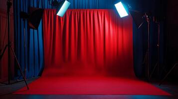 Illuminated stage setup with vibrant red backdrop and professional lighting equipment creating a dynamic and visually striking scene. photo