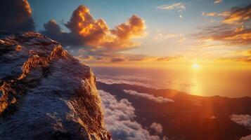 Cliffside view of an ocean sunset. Clouds glow against the mountains, sky, and sea. Dreamy, serene, and beautiful landscape. photo