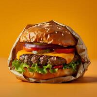 Fast food staple Hamburger on a bun, wrapped in brown paper photo