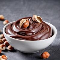 Chocolate cream with hazelnut, soft paste in a bowl. Dark chocolate, cocoa. Close-up food image. Design element photo