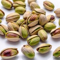 Pistachios close-up scattered on a white background. Macro image of food. Design element photo