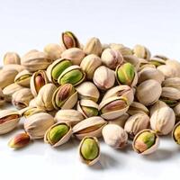 A bunch of pistachios, peeled and in shell, close-up, scattered on a white background. Macro image of food. Design element photo