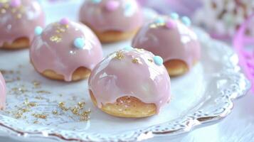 Pink donuts on a white plate with sprinkles photo