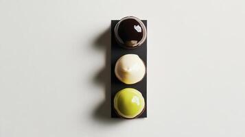 Three different colored eggs on a black plate photo