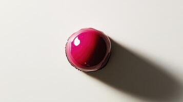 A pink object on a white surface photo