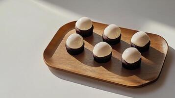 Five white eggs on a wooden tray photo