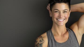 A woman with tattoos and a tank top photo