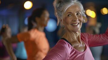 An older woman is smiling while doing a dance class photo