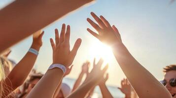 Many people with their hands up at a music festival photo