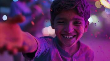 A boy is smiling while holding a paint pot photo