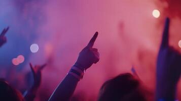 People at a concert with their hands up photo
