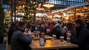 People sitting at tables with beer at a christmas market photo