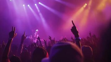 A crowd at a concert with their hands up photo