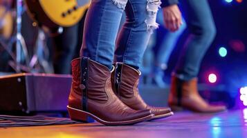 A woman in cowboy boots standing on stage photo