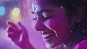 A woman is covered in pink powder and smiling photo