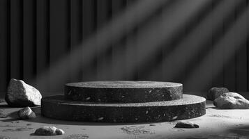 Black and white photo of a stage with rocks and a spotlight