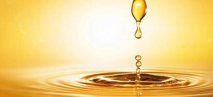 A drop of oil is falling into a pool of water photo