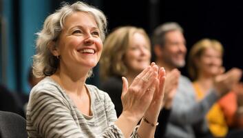 Audience clapping and smiling during a performance or event. photo