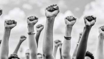 Raised fists symbolize unity and resistance in a peaceful protest. photo