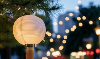 A decorative lantern illuminated among soft bokeh lights at dusk. photo