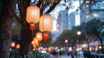 Lanterns glow softly in an urban setting during twilight. photo