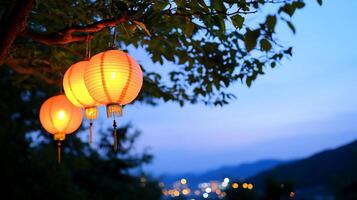 Three glowing lanterns hanging from a tree at dusk, creating a serene atmosphere. photo