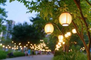 Lanterns illuminate a serene park pathway during twilight. photo
