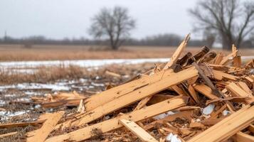 Collapsed barn in a rural field after a violent tornado, broken wood and twisted metal scattered across the landscape photo