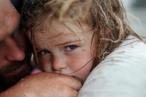 A man and a little girl are hugging each other photo