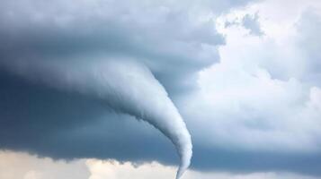 A tornado is seen in the sky above a field photo