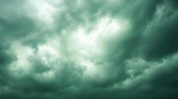 A dark green sky with clouds and some white clouds photo