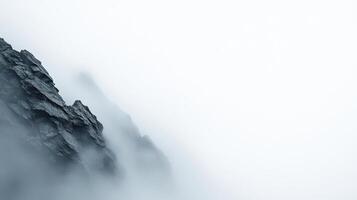 Monochrome mountain silhouette against a deep foggy sky, soft light, dramatic mood. photo