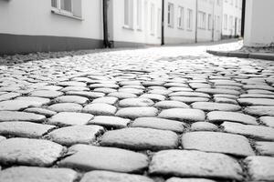 Black-and-white cobblestone street scene, vintage charm, timeless aesthetic, soft morning glow. photo