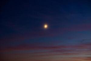 Glowing crescent moon on the hazy sky. Ramadan concept photo