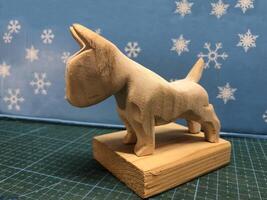 small wooden figurine of a bull terrier stand photo