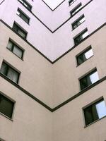internal corner of the building, wall with windows, dead end, multi-story building modern architecture, low angle view photo