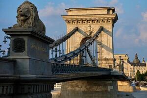 Szechenyi Chain bridge in Budapest at Sunset. Famous bridge over Danube river connecting Buda and Pest. Historical architecture in Hungary photo